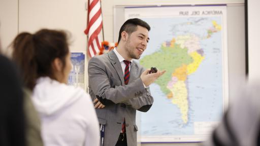 Professor standing in front of map